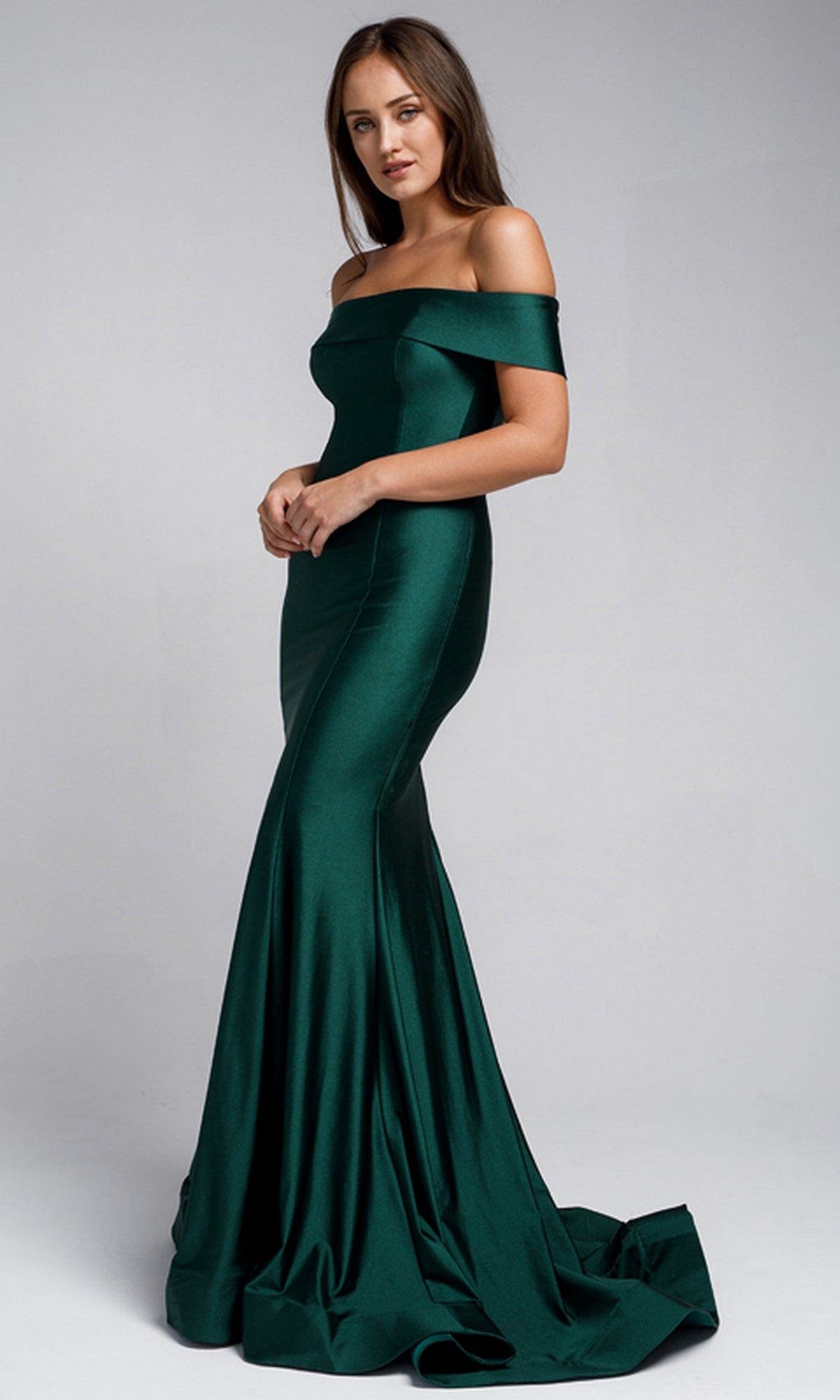 A woman models the Sleek Simple Off-the-Shoulder Long Prom Dress 373, a floor-length, fitted emerald green gown, against a plain light background.